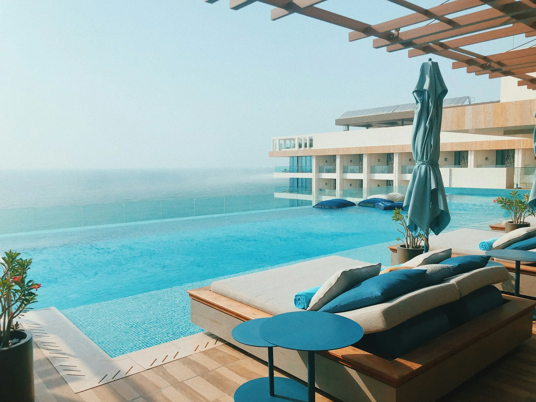 Luxury coastal hotel terrace overlooking blue water